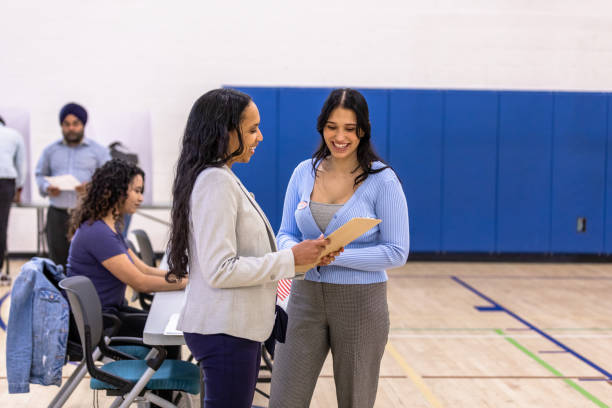 istock Female candidate meets with her campaign manager as they receive voting results 1588098878
