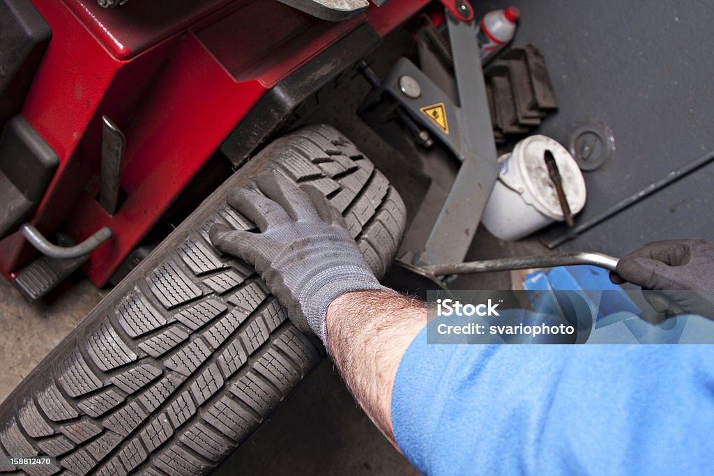 Mecânico reparo de pneu na garagem. - Foto de stock de Adulto royalty-free