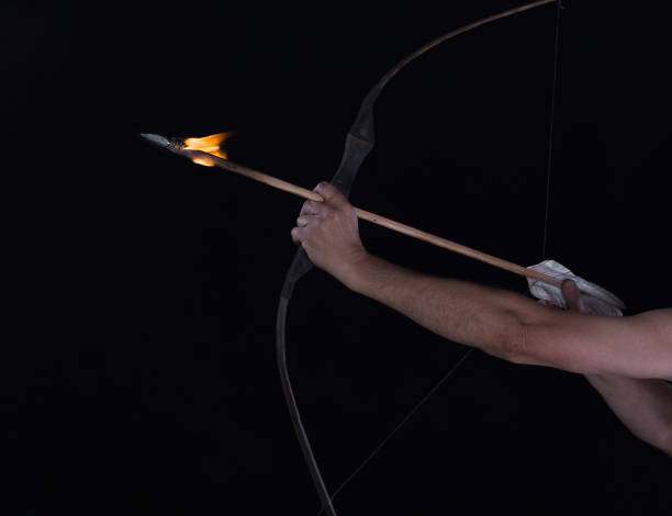 archer shoots a flaming arrow from a bow