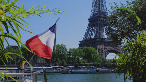 istock Eiffel Tower with a French flag on a blue background. 1588164023
