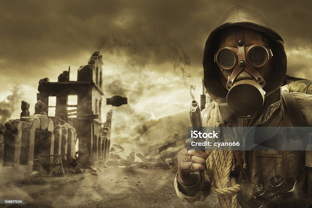 Post apocalyptic survivor in gas mask Post apocalyptic survivor in gas mask, destroyed city in the background Adult Stock Photo