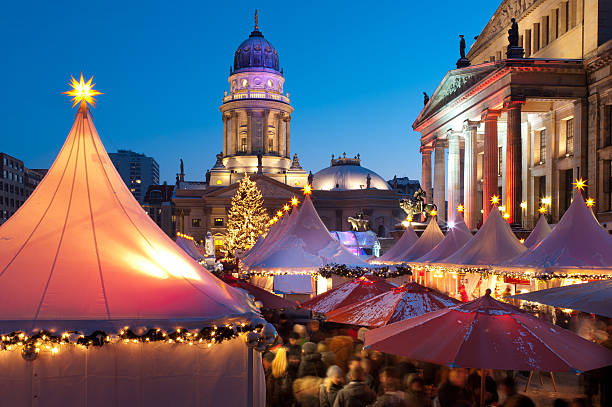 Christmas market in Berlin Christmas market at Gendarmenmarkt in Berlin Mitte. The German Cathedral (Deutscher Dom) in background and the Konzerthaus at the right side. east berlin photos stock pictures, royalty-free photos & images