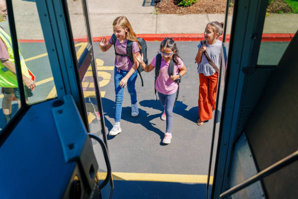 istock Elementary age girls boarding school bus 1588211367