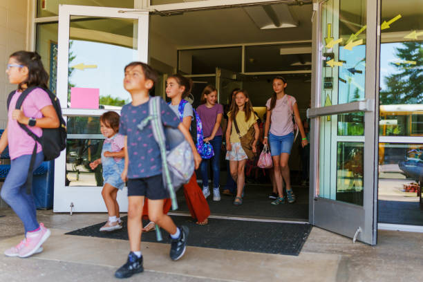 istock Students leaving school at the end of the day 1588211901