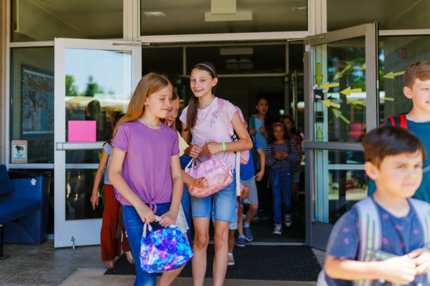 istock Happy female students leaving school 1588211908