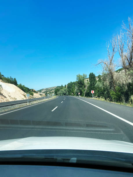 istock Driving on asphalt road on a sunny day 1588223388