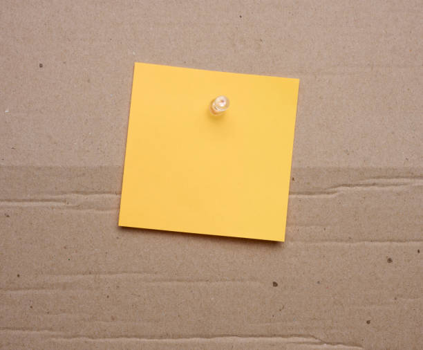 istock Yellow paper blank stickers attached with a button, space for notes and labels 1588226723