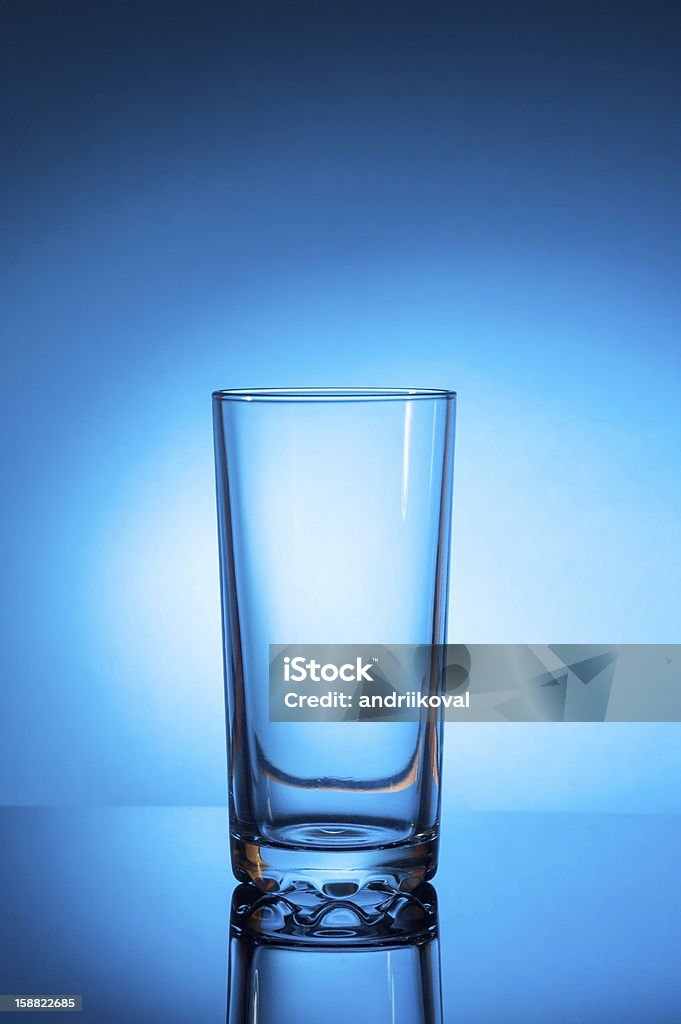Empty glass on blue background Empty glass on blue background studio shot Blue Stock Photo