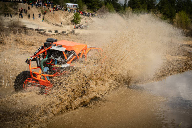 istock Fast ATV and UTV driving in mud and water. Quad racing, ATV 4x4. 1588243596