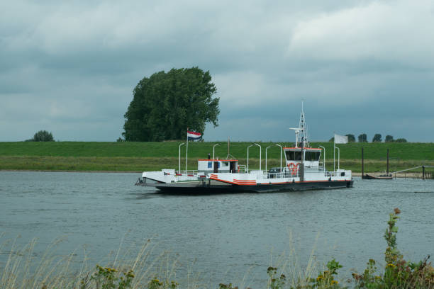 ferry across the river Lek between Beusichem and Wijk bij Duurstede in the province of Utrecht, the Netherlands ferry across the river Lek between Beusichem and Wijk bij Duurstede in the province of Utrecht, the Netherlands lek river in the netherlands stock pictures, royalty-free photos & images