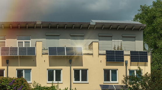 Typical apartment houses with solar panels in autumn. (Germany)