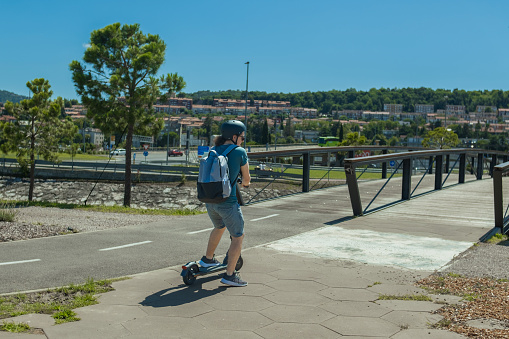 One young man commuting with an electric scooter for short distances