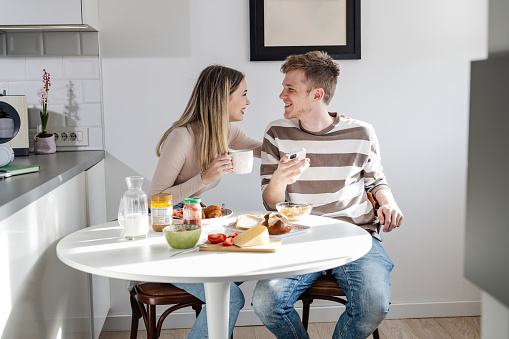 Young couple enjoying breakfast in the morning