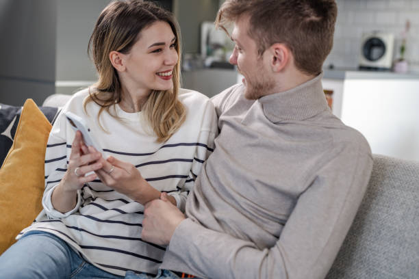 istock Couple at home, using phone 1588279818
