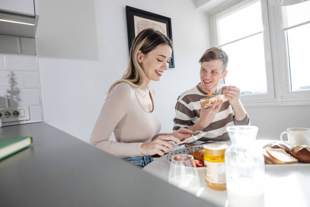 istock Young couple enjoying breakfast together 1588279823