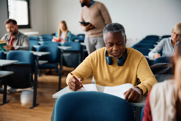 istock Senior black man attending educational course in the classroom. 1588285788