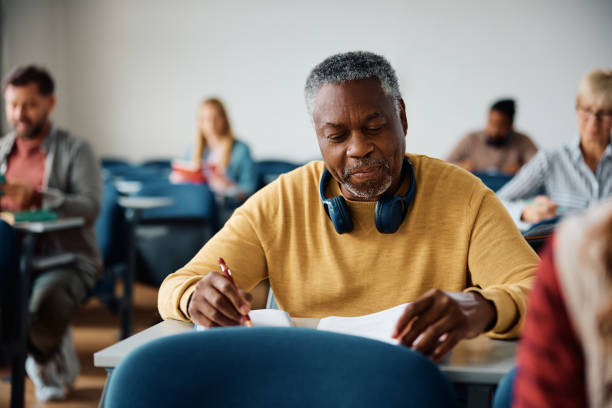 istock Black senior student writing an exam in lecture hall. 1588285789