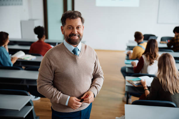 istock Portrait of happy university teacher during a class looking at camera. 1588289437
