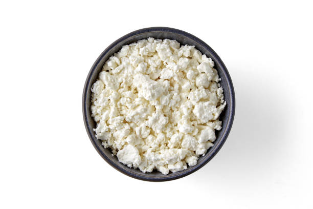 istock Gray ceramic bowl with grained cottage cheese isolated on white background. Top view with copy space 1588295226