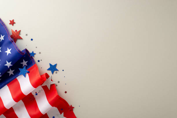 istock Honoring laborers on Labor Day: Engage your audience with this top-view photograph, showcasing flag and glitter confetti on light grey isolated background. Great for advertisements or content creation 1588314343