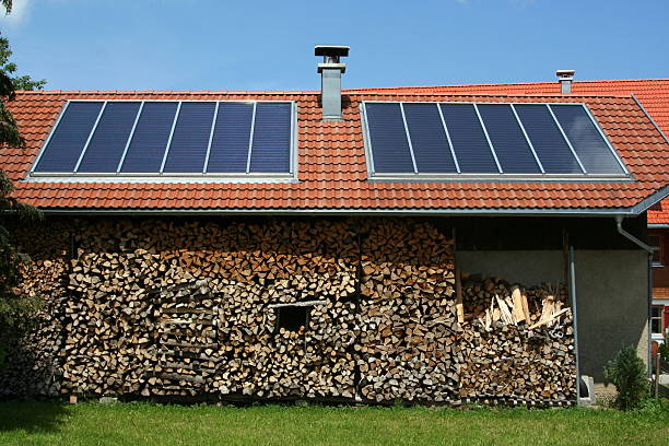 Solar pannels on a roof with wood infront