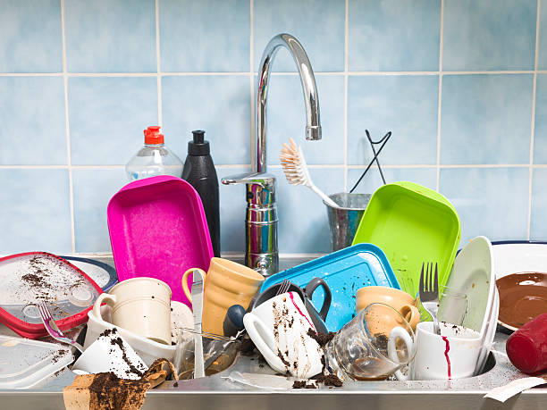 Kitchen sink full of dirty dishes  stock photo