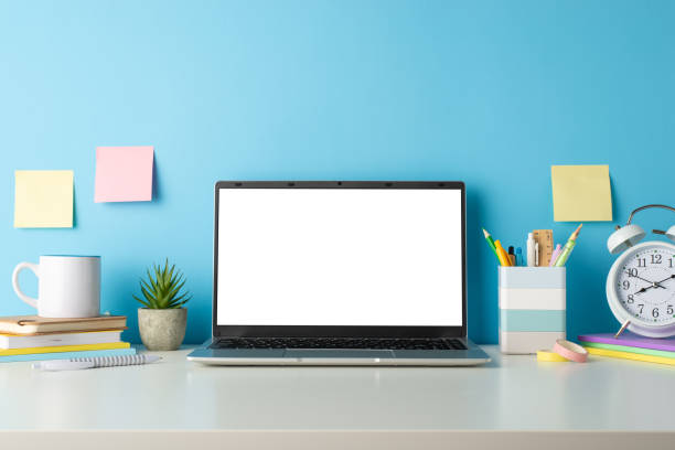 istock Transform your distant education materials with a side view capture of a white desk, computer and school supplies on an isolated blue background, designed for text or advertising incorporation 1588320225
