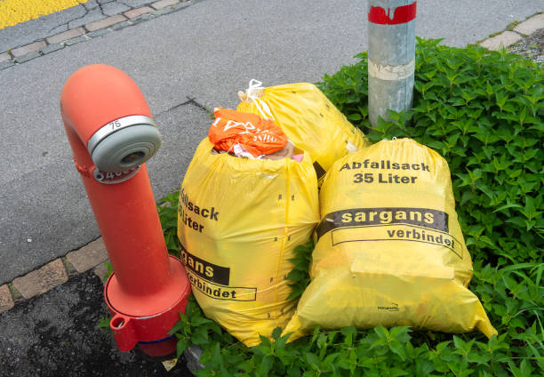 Sargans, Switzerland - July 26, 2023: Full yellow garbage bags of the swiss town of Sargans
