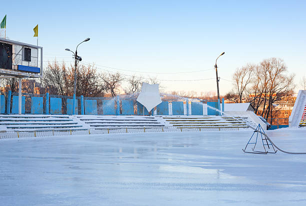 istock Winter work on filling the stadium with water. Skating 158832564