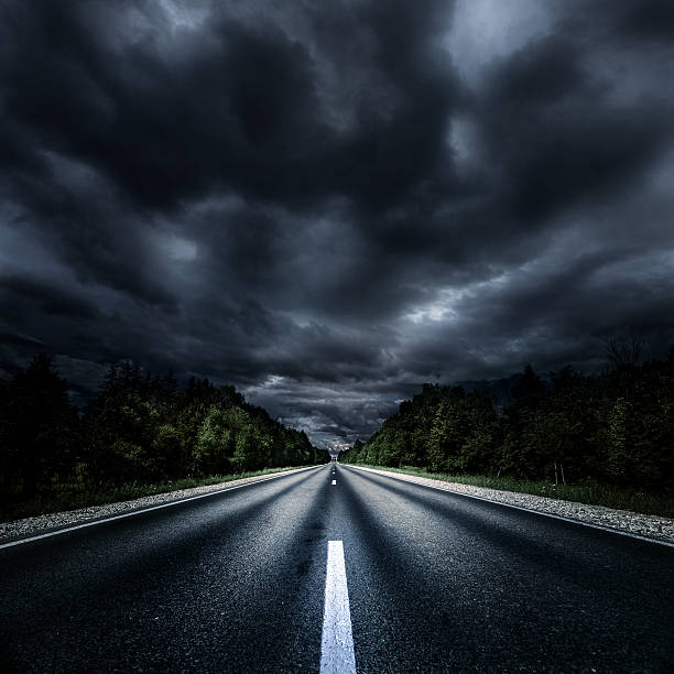 Way forward Asphalt road at storm. Forward direction. all weather running track stock pictures, royalty-free photos & images