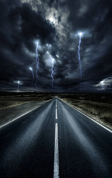 Way forward Asphalt road at storm. Forward direction. lightning storm natural disaster cloud stock pictures, royalty-free photos & images