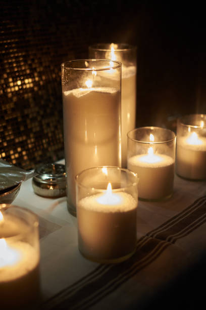 Hamam accessories and candles on a stone table. Massage therapy with candle light. Beauty spa treatment and relax concept.
