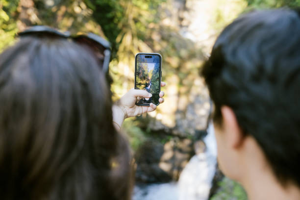 istock Hiking Couple Take Selfie By Waterfall 1588352118