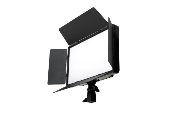 istock Photo and video lamp isolate on white background. LED lamp with special shutters for the formation of light flux. Photo and video lighting fixture. 1588365656