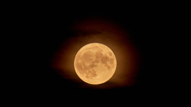 istock Full Orange Moon movement across the sky 1588382056