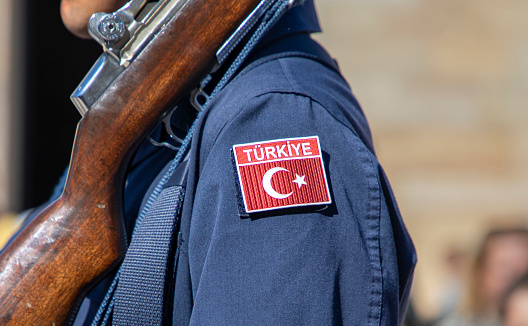 Turkish soldier holding a gun and Turkish flag symbol