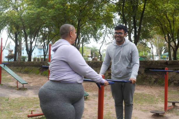 istock couple working out in public park games 1588393639
