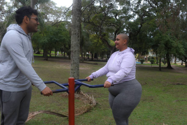 istock couple working out in public park games 1588393641