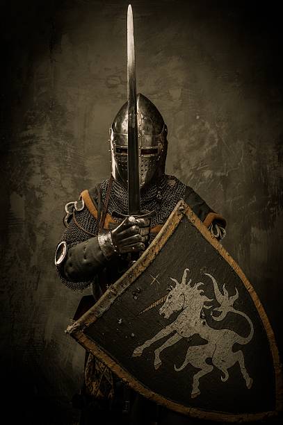 Medieval knight on grey background Medieval knight on grey background sword photos stock pictures, royalty-free photos & images