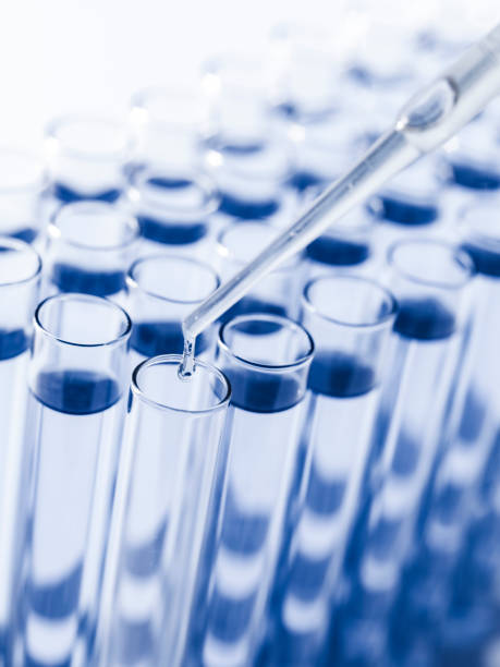 istock Droplet Falling from Pipette into Test Tube. 1588449624
