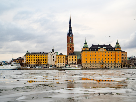 View of the city of Gamla Stan in Stockholm (Sweden) during winter with the frozen river . High quality photo