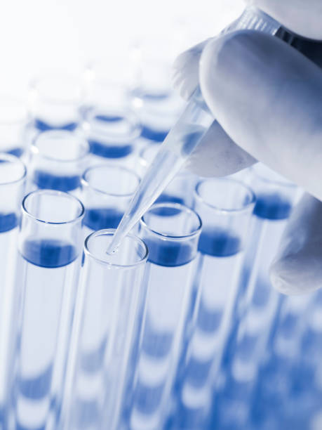 istock Droplet Falling from Pipette into Test Tube. 1588458315