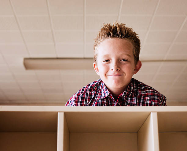 istock Cute boy caught spying from above the lockers 158847339