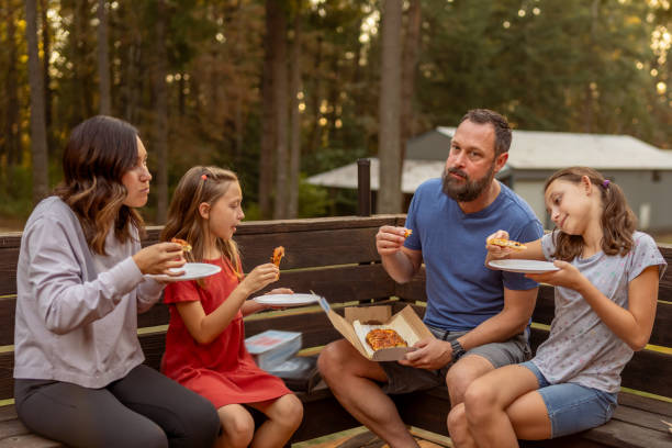 istock Family eating dinner at home on the back patio 1588478767