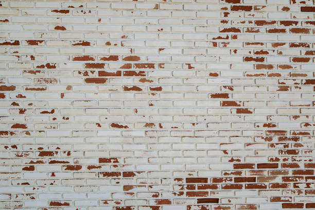 Close-up on an old painted brick wall.