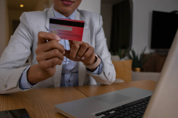 istock Cheerful  woman doing online shopping 1588572122