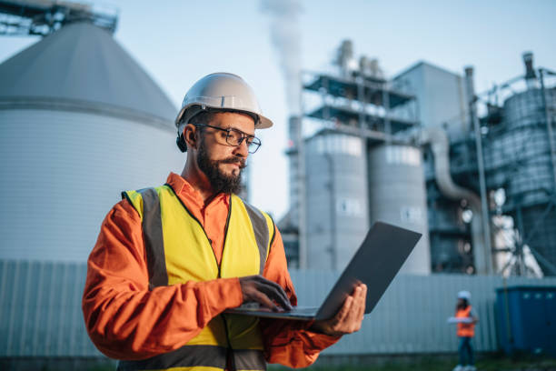 istock Hard working engineer on the power station with laptop. 1588582733
