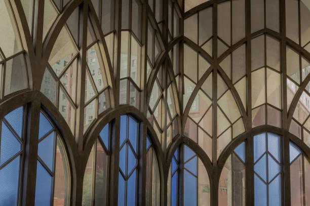 Antique multicolored stained glass window panel are decorated in monastery chapel.