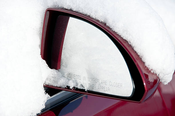istock Red car mirror in bright snow 158860639