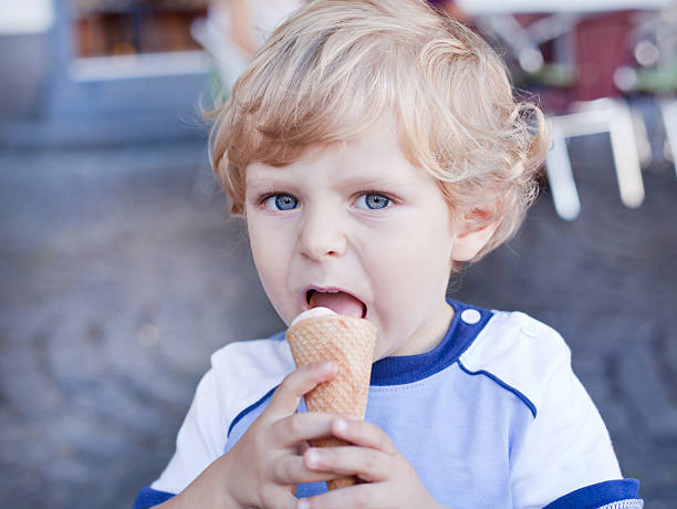 istock Adorable toddler boy eating ice cream in cone 158861099